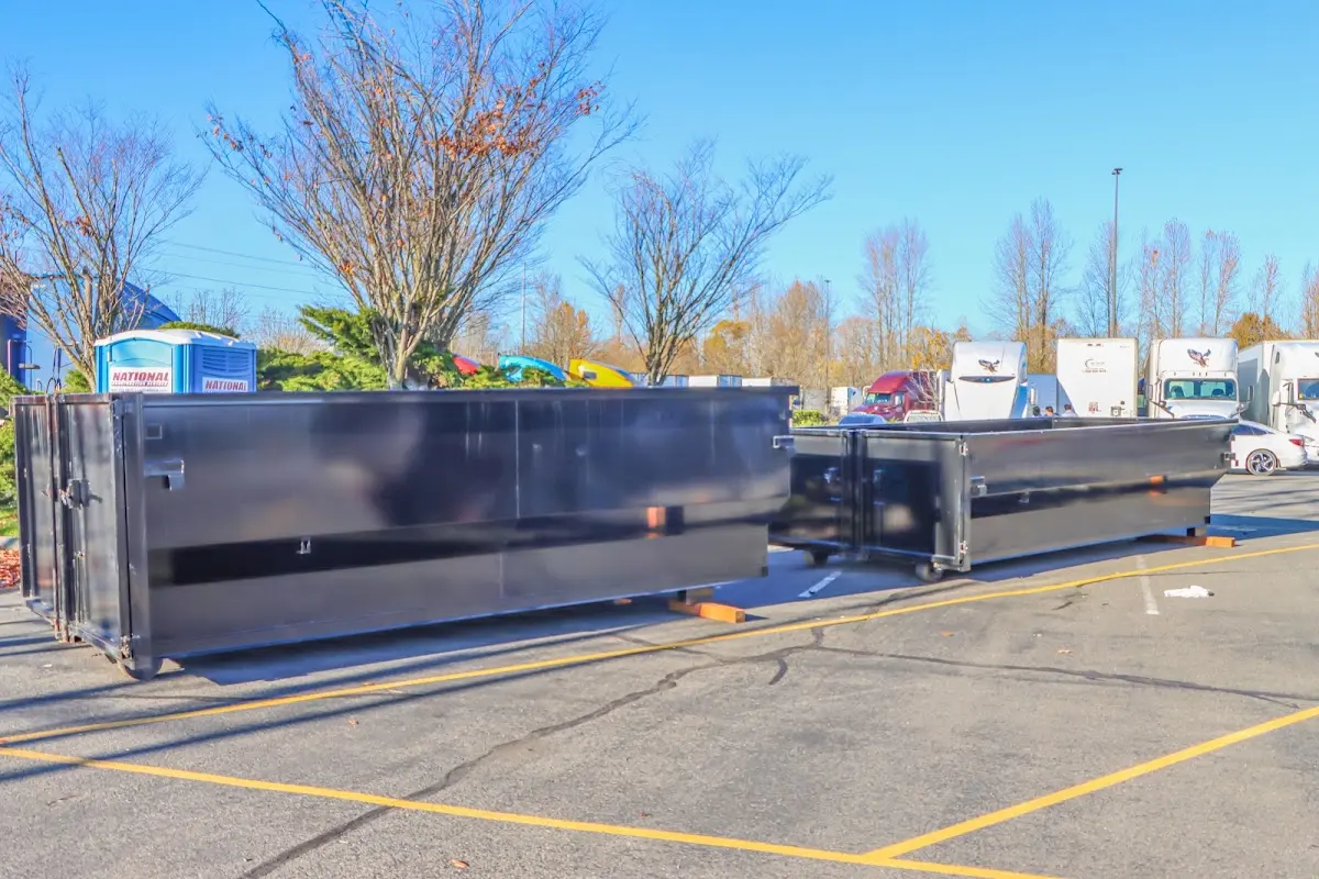 Professional dumpster rental service with roll-off container on residential driveway in Tacoma